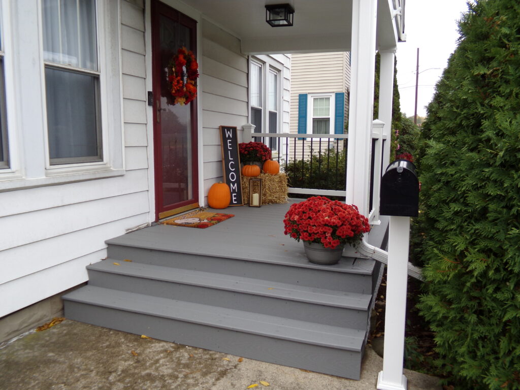 Dan Brown Trex Deck Porch in front of house with plants