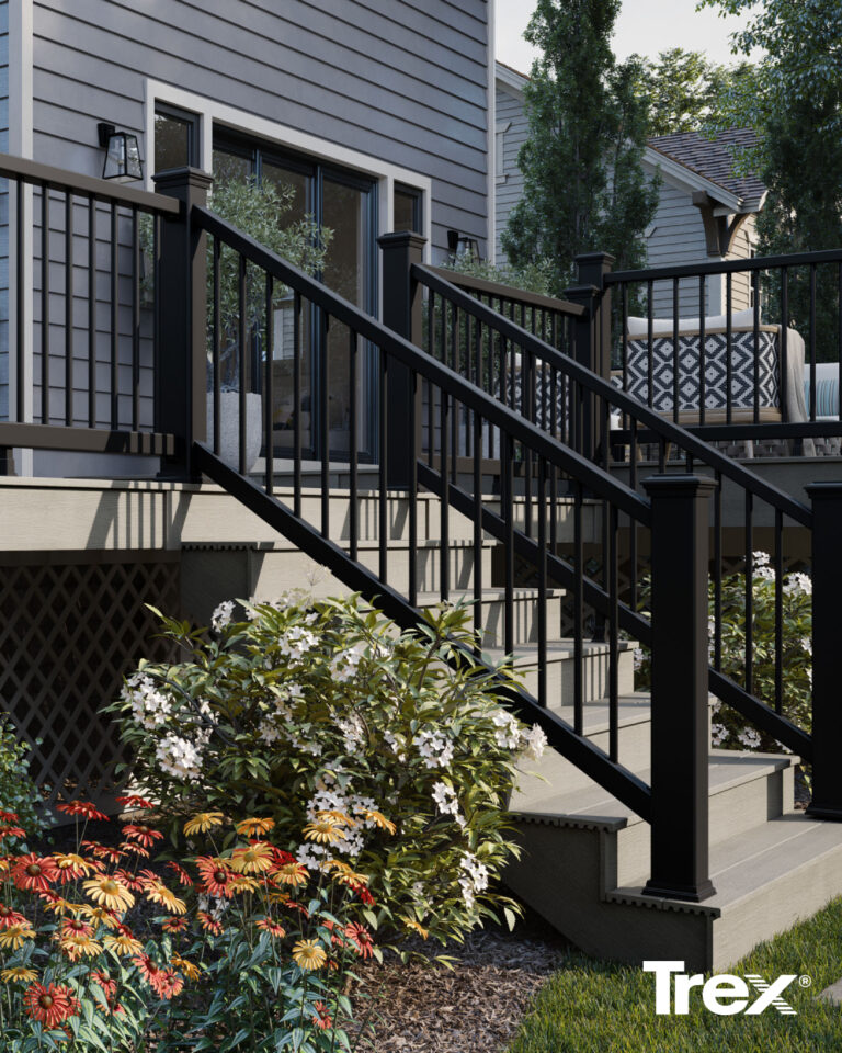 Photo of white stairs with black fence and railing on trex deck with flowers